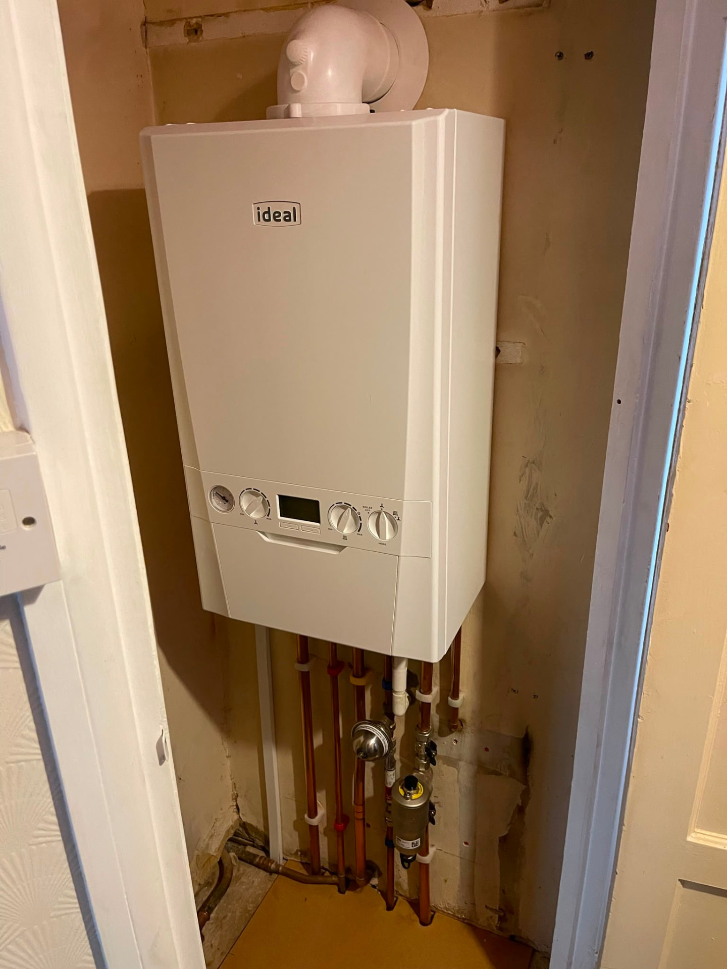 Ideal boiler installation in an airing cupboard with magnetic system filter fitted by Gas Safe registered engineers in Essex
