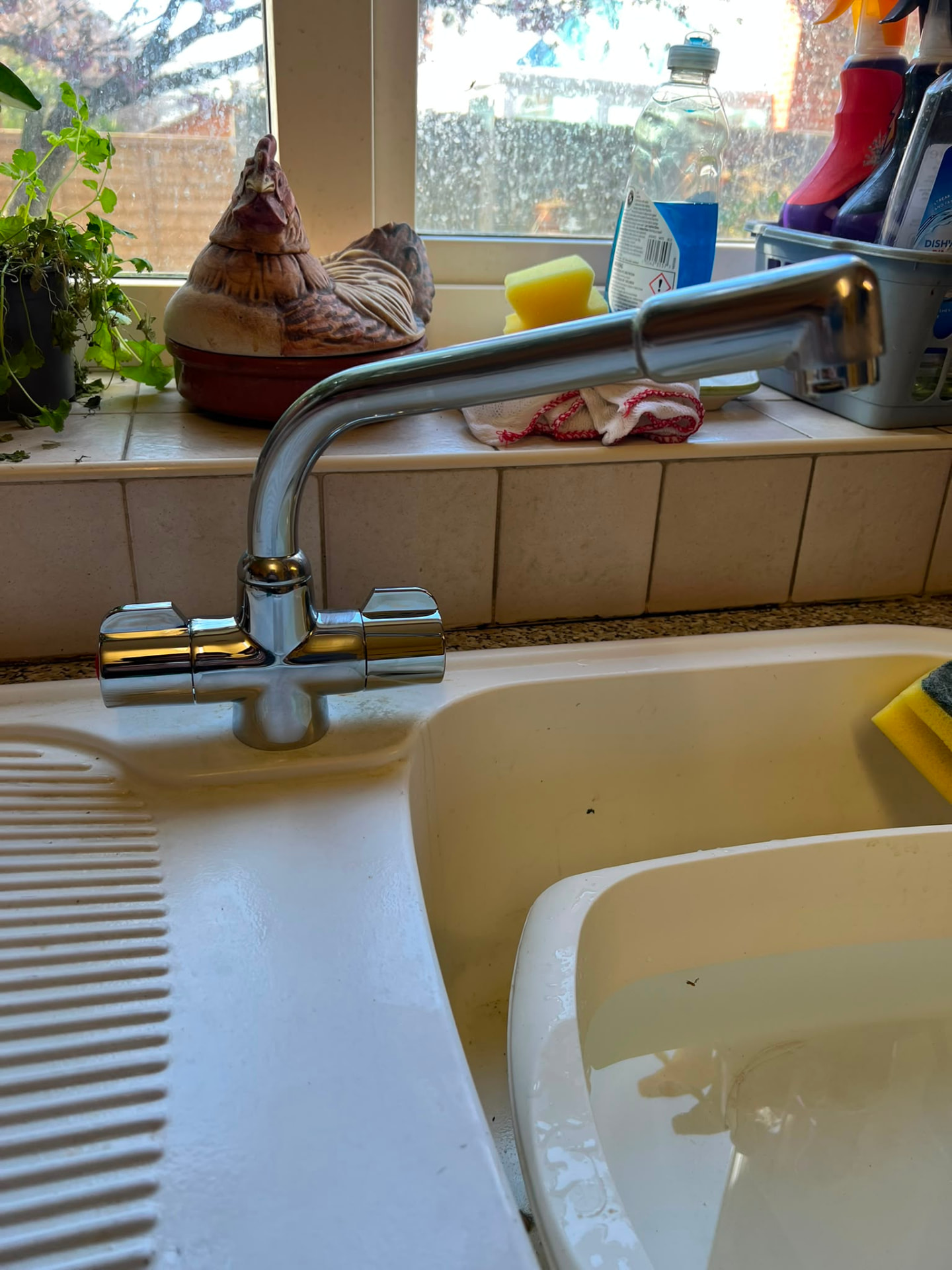 Kitchen mixer tap installation with pull-out spray on a white sink, fitted by Gas Safe registered engineers in Essex