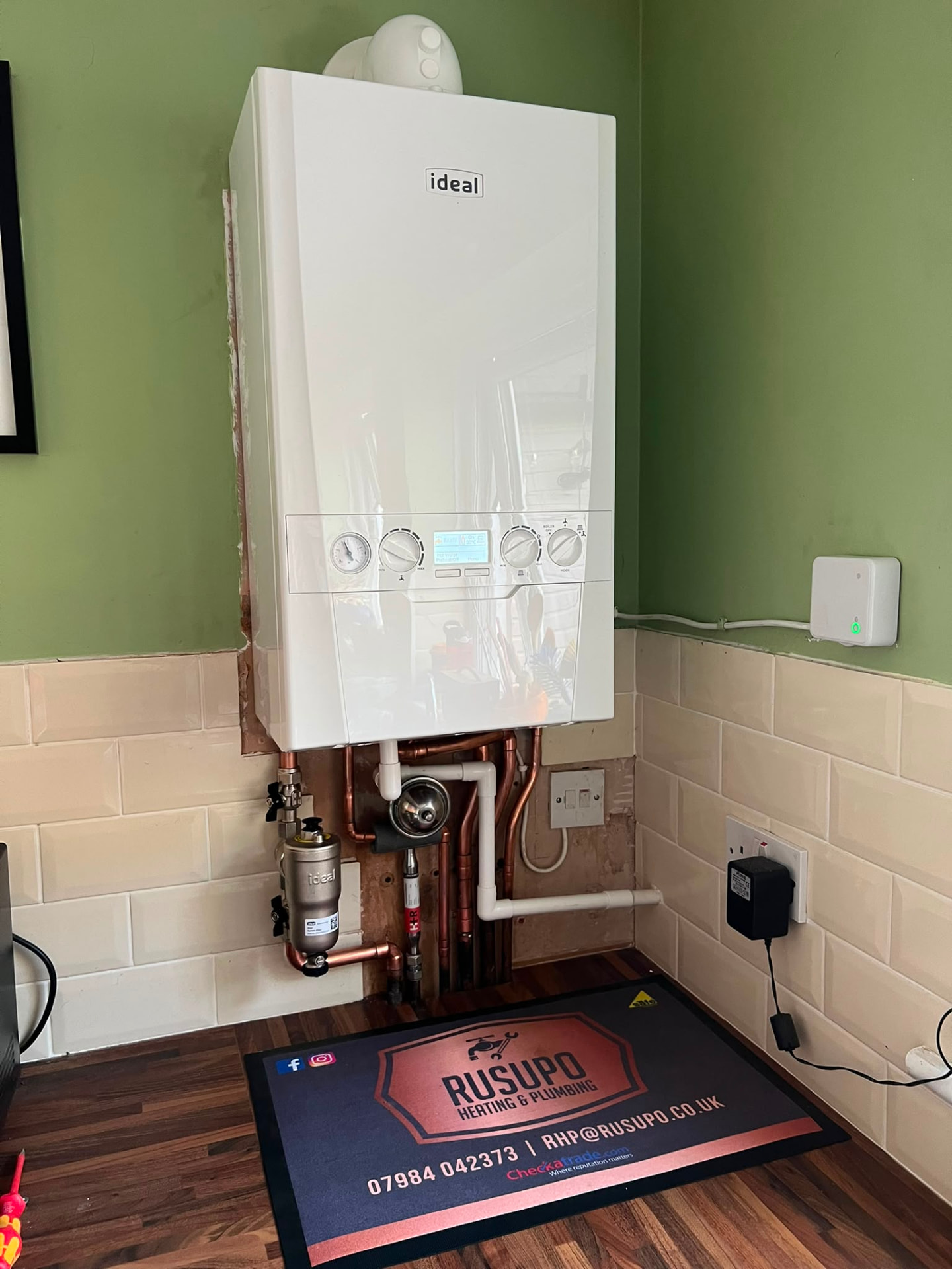 Ideal combi boiler installation in a kitchen with new copper pipework and filter, fitted by Gas Safe registered engineers in Essex