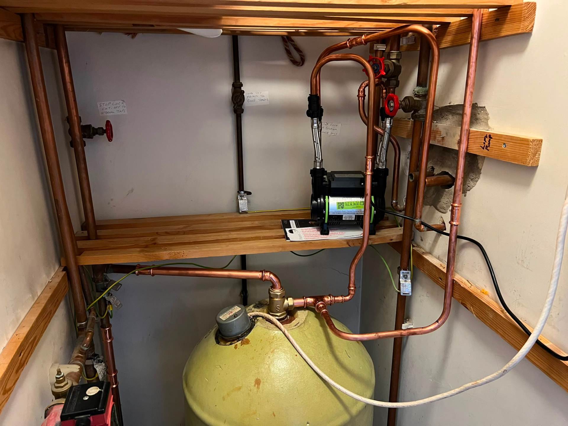 Twin shower pump installation above a hot water cylinder to boost shower pressure, fitted by Gas Safe registered engineers in Essex