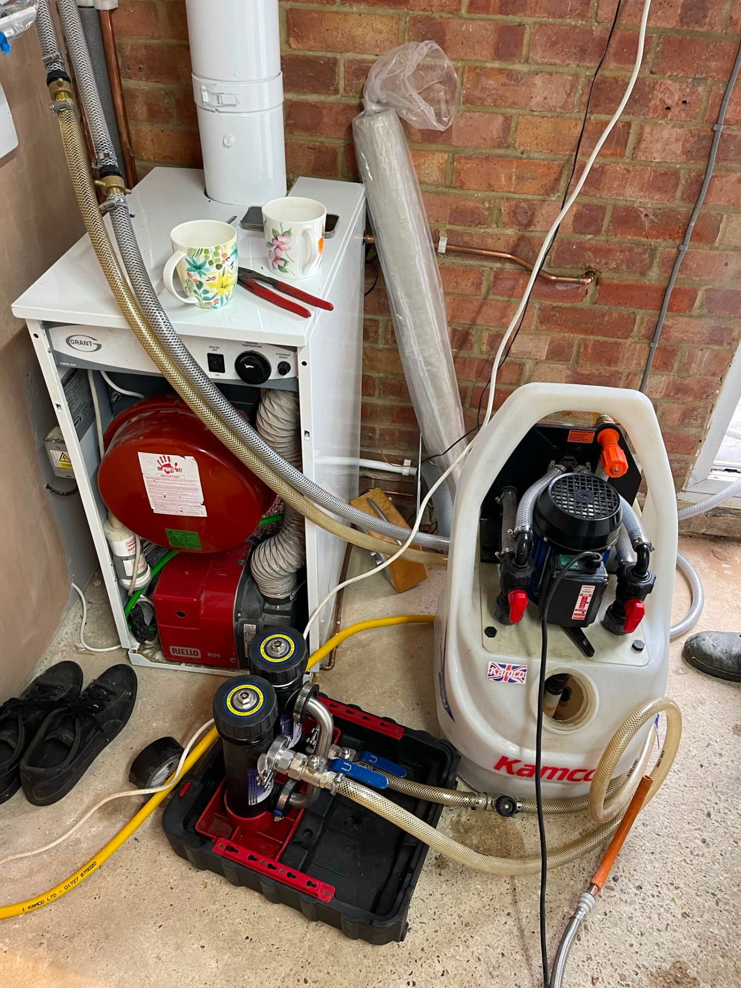 Powerflushing machine connected to an oil-fired boiler and heating system, fitted by Gas Safe registered engineers in Essex